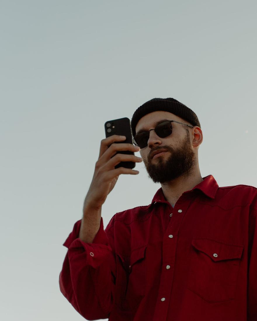 Man holding his phone up for a selfie liveness check